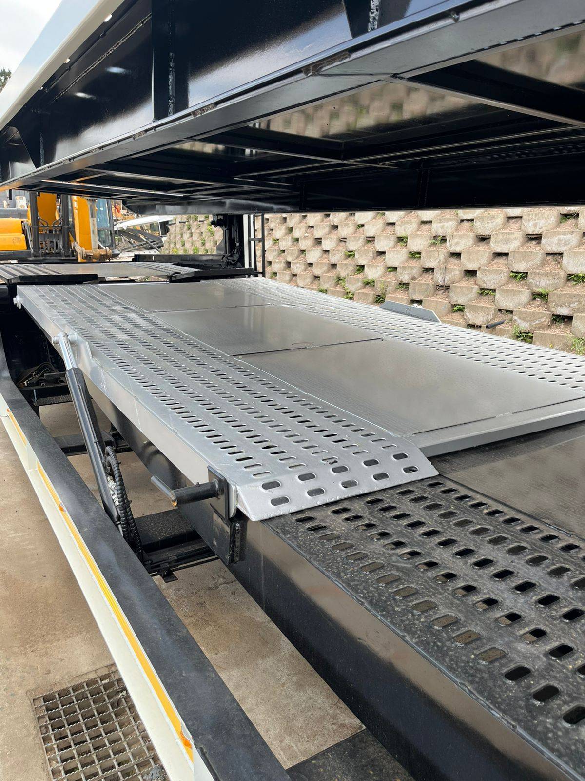Close-up of perforated steel deck plates on the trailer