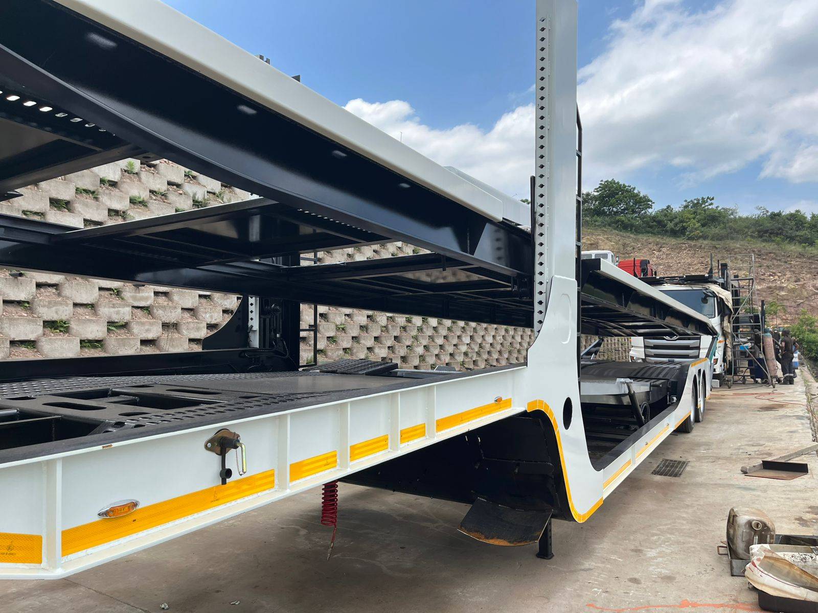 Heavy-duty car carrier trailer rear deck and tail ramp at the workshop