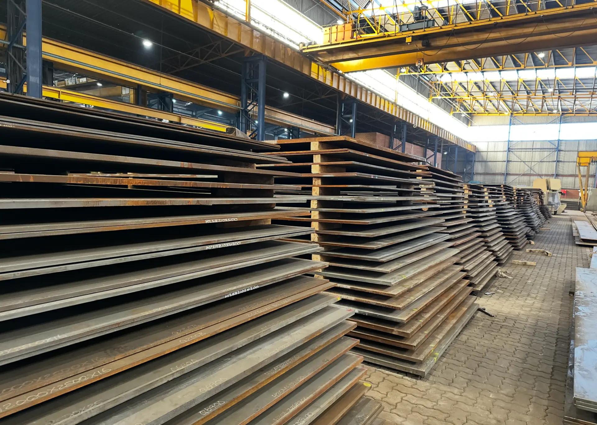 Stacks of carbon steel plate in the Steel Plate Solutions warehouse